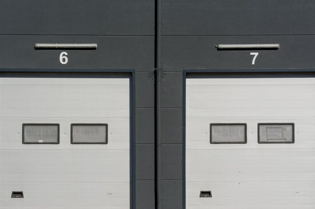 Close-up of modern garage doors numbered 6 and 7 on an industrial building facade.