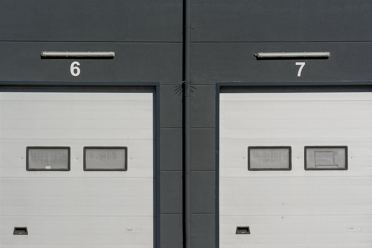Close-up of modern garage doors numbered 6 and 7 on an industrial building facade.